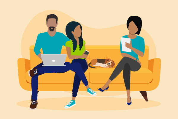 Family sitting on sofa, reviewing college loans on a laptop and pieces of paper